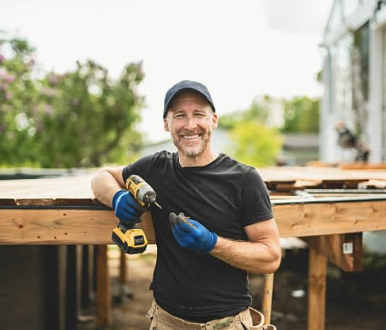 A Handyman worker making patio outside close to a pool